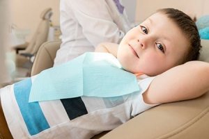 small boy in dental examining chair 