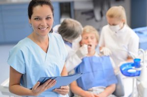 staff smiling with patient and dr
